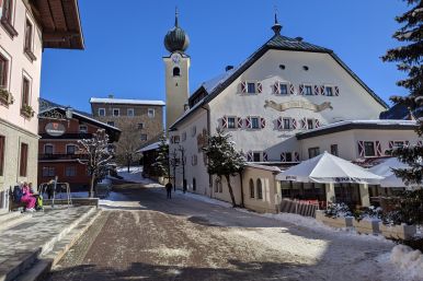 Hotel Post in the town of SaalBach on a sunny day with snow on the ground