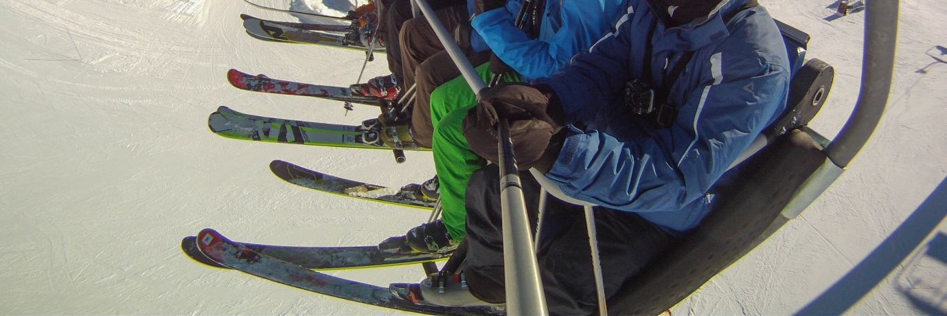 Guided skiers on a chairlift