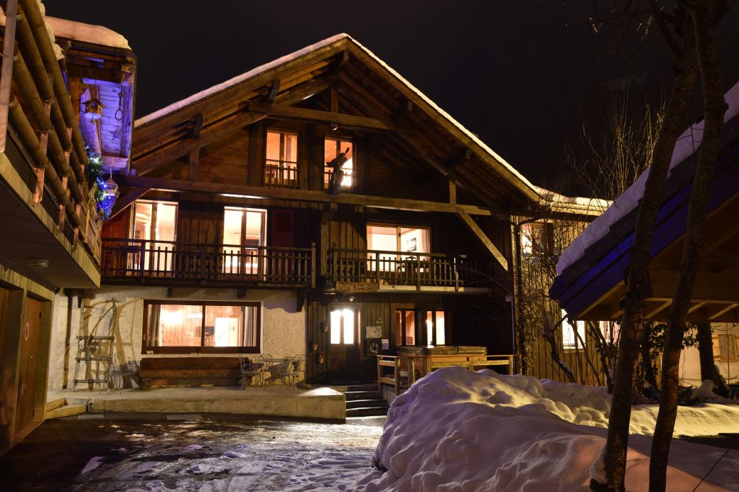 Ardoisiers Exterior front of chalet at night