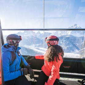 Pair of skiers in a bubble lift