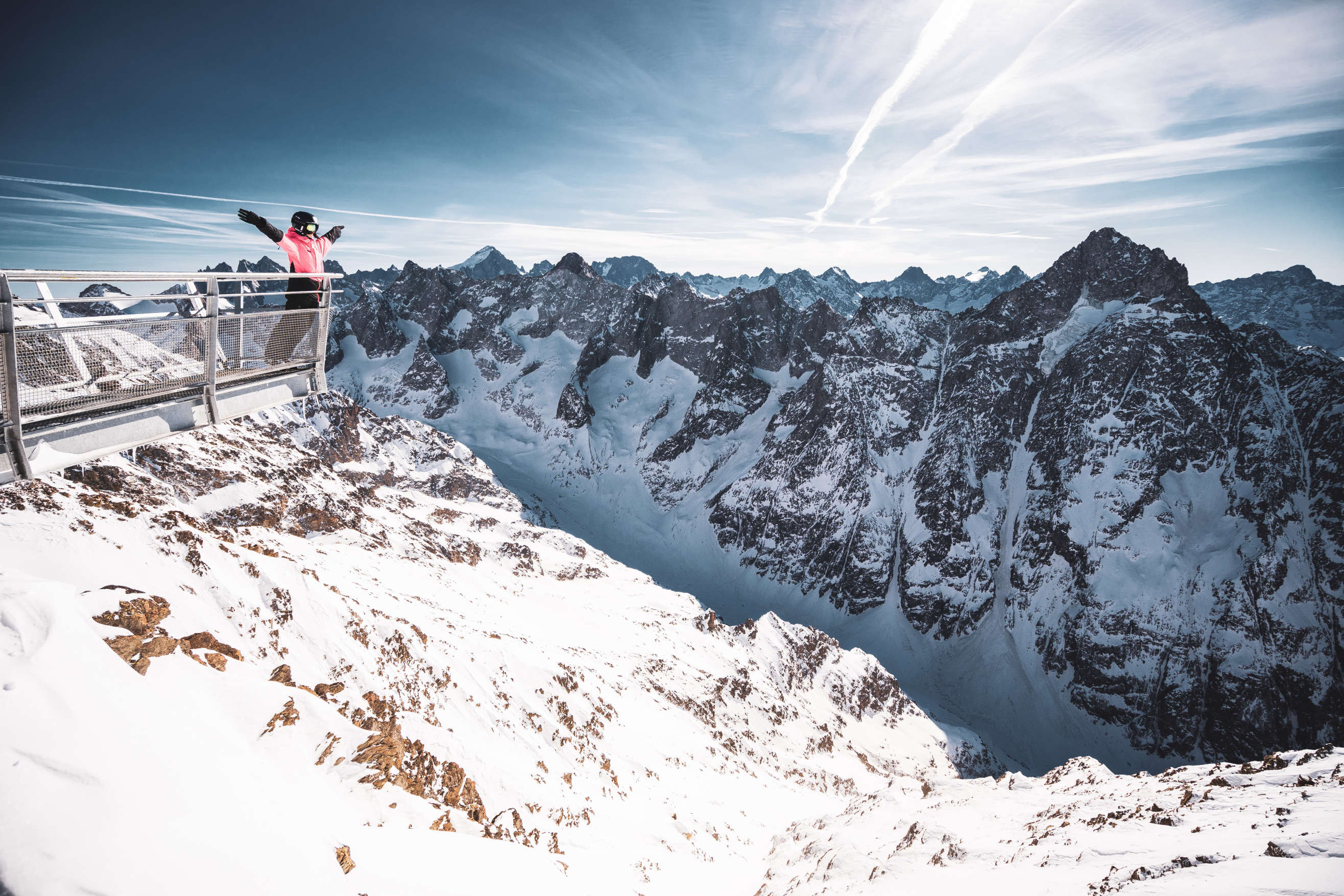 Single skier looking over Ecrins mountains from Belvédère Des Ecrin