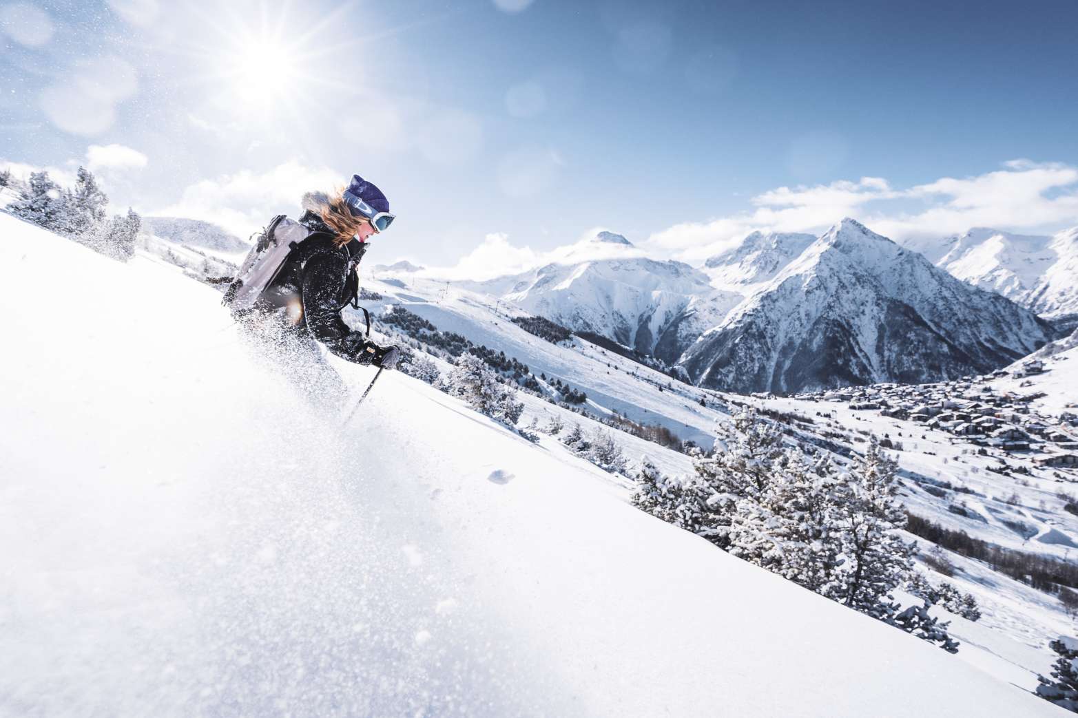 Solo skier heading down the piste