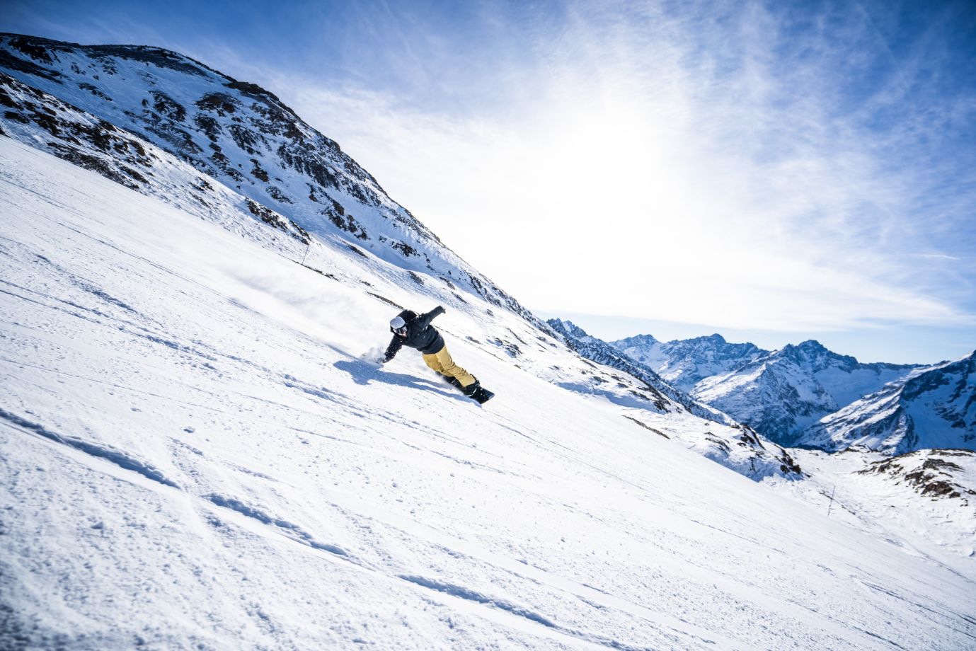 Snowboarder carving up powder