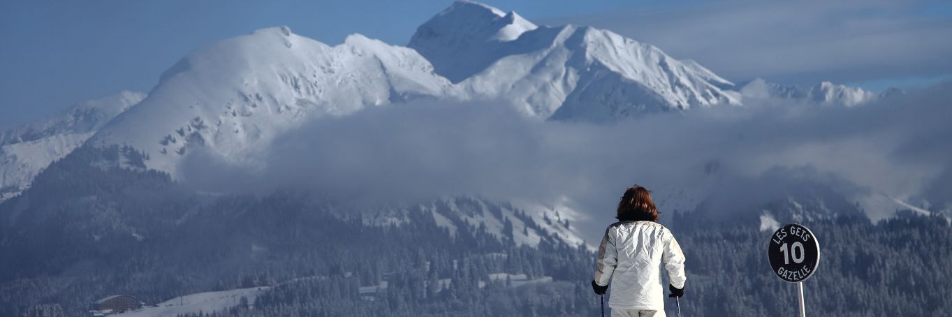 A Lady on skis looking at les gets