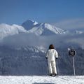 A Lady on skis looking at les gets