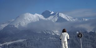 A Lady on skis looking at les gets