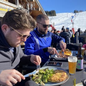 Skiers enjoying lunch on the side of the slopes in Les Gets