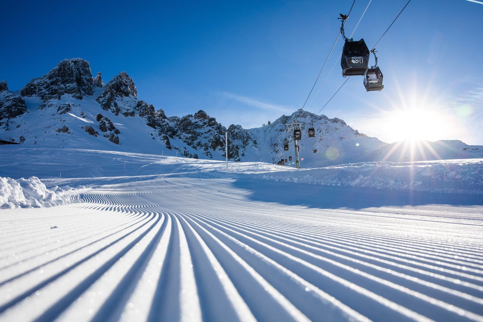 Freshly groomed piste with a chairlift in Meribel