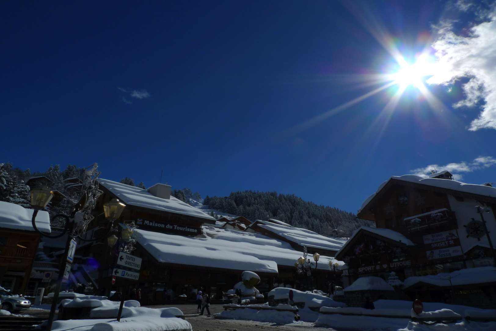 The late-season sun seen through scudding clouds above Meribel