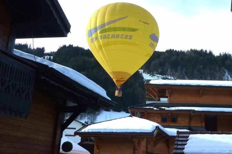 Hot air balloon over the chalet rooftops in Morzine ski resort