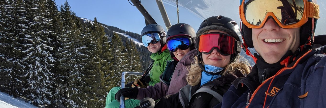 Skiers on a lift telling solo ski holidays stories and experiences