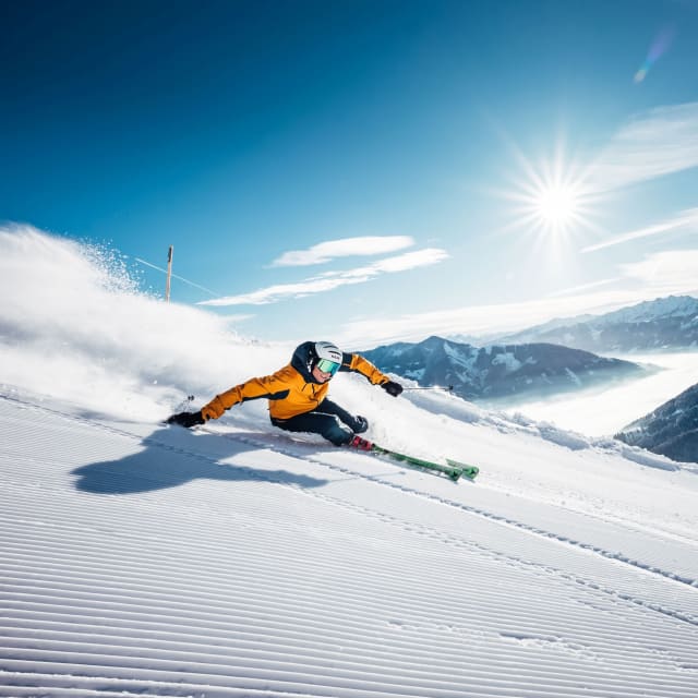 Avid skier on a steep slope with The Ski Gathering
