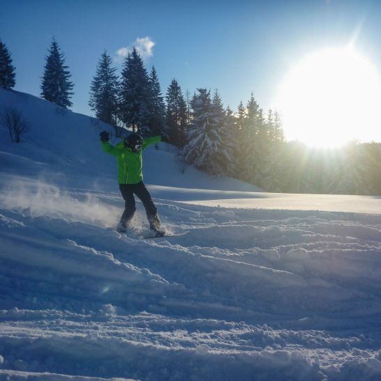 Snowboarder in Les Gets at sunset