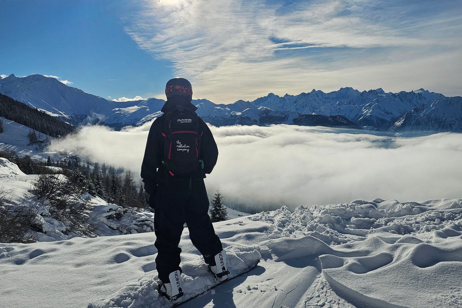 Solo snowboarder at the top of the mountain
